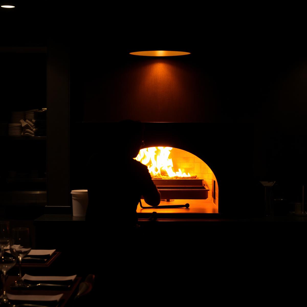 Wood-fired oven glowing in the La Fontana kitchen